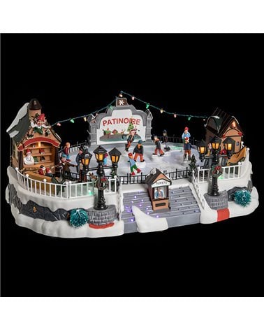 Pueblo navideño iluminado, pista de hielo